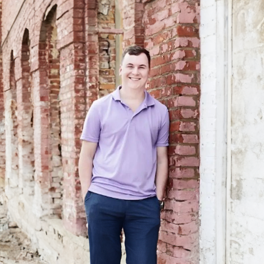 dr smiling outside with purple polo